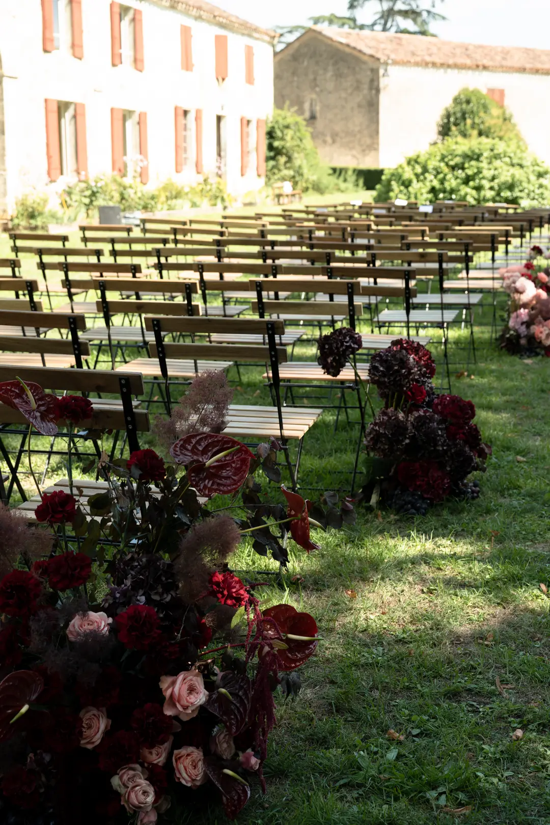 Compositions d'allée de cérémonie fleurie – mariage Harriett & Oliver, Château de Poudenas